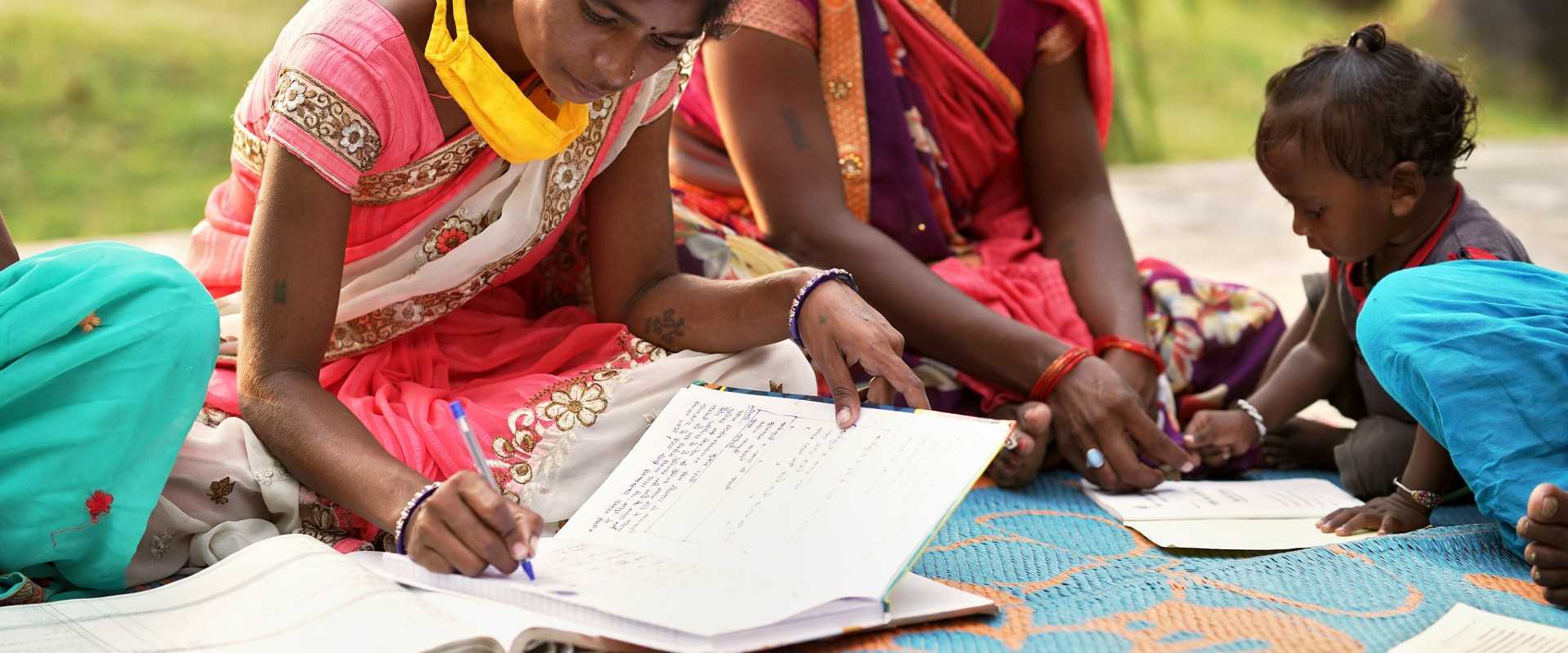 photo of a young girl and toddler learning