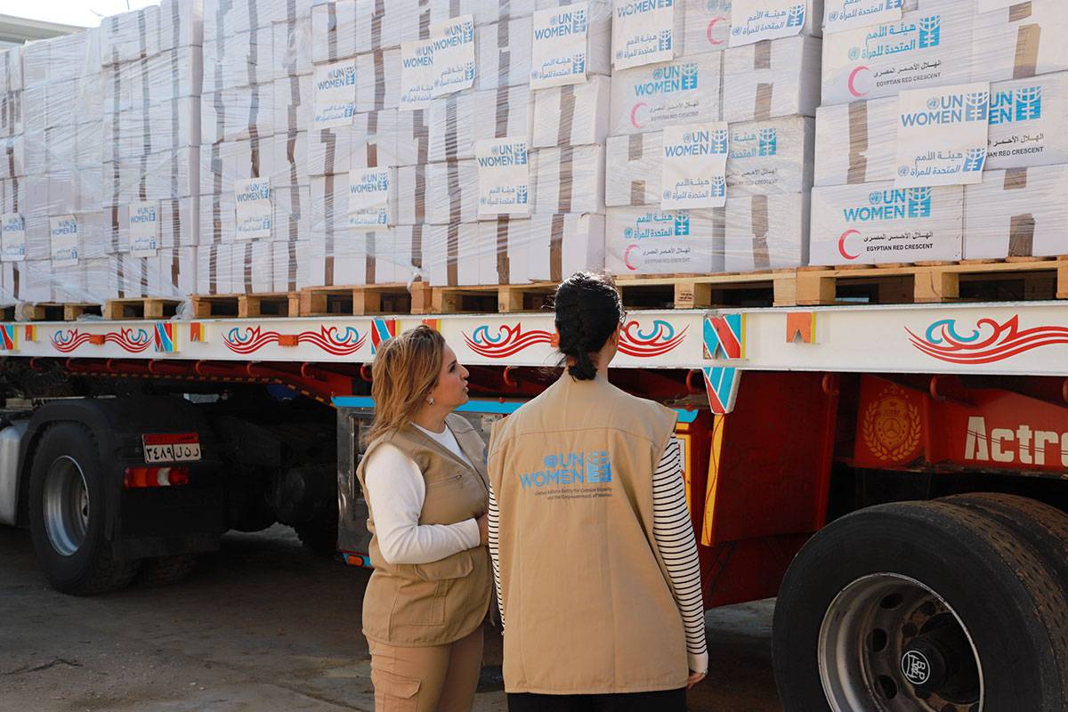 UN Women team checks a shipment of humanitarian aid to Palestinian women and children. UN Women Egypt in partnership with the Egyptian Red Crescent delivered desperately needed humanitarian aid to Palestinian women and children in Gaza. Egypt, Ismailia Governorate, January 2024. Photo: UN Women/Menna Negeda.