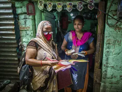 In India, Geeta Devi, a SEWA Bank Saathi (“bank friend”, trained local counsellor), collects the monthly installment from a member. SEWA Bank (Self-Employed Women’s Association Bank) and UN Women have collaborated on women’s economic empowerment, with SEWA Bank’s innovative model and savings-first approach inspiring global initiatives. Photo: UN Women/ Prashanth Vishwanathan.