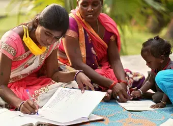 photo of a young girl and toddler learning