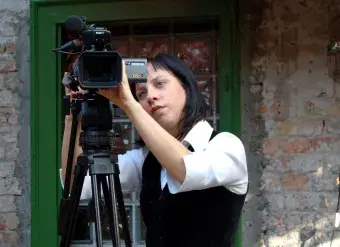 A woman works with her camera. Photo: UN Women / Dragana B. Stevanovic