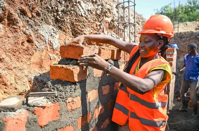 In Uganda, Grace is one of the few women working on construction sites as a mason. Her workmanship is valued, and she is held in high regard because of her skills, hard work, and punctuality. Photo: UN Women/James Ochweri.