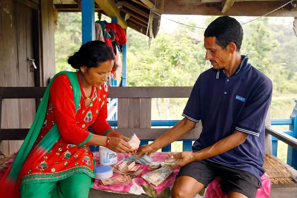 Chandra Kala Thapa along with her husband Bir Bahadur Thapa keep track of income from the sale of recently-harvested eggplant.